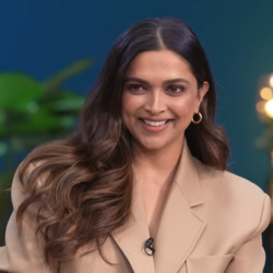 Deepika Padukone smiling to the left of the camera